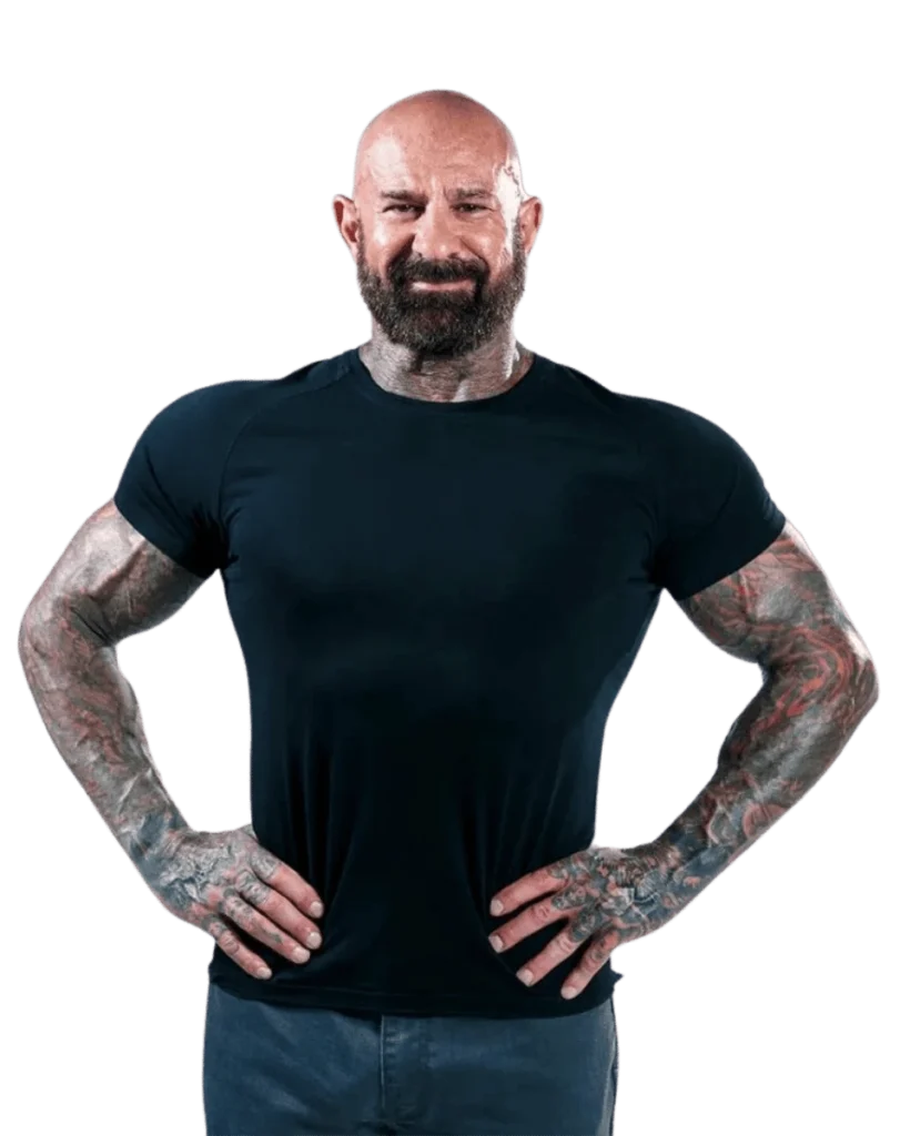 A man, adorned with tattoos on his arms, embodies the dedication of a personal trainer and the expertise reminiscent of Dr. Jim Stoppani.